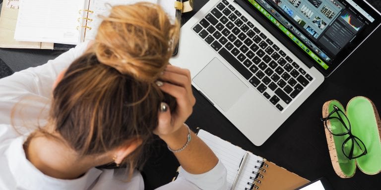 Young business woman stressed out over laptop